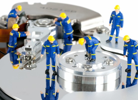 Group of workers repairing HDD. Hard Drive repair concept